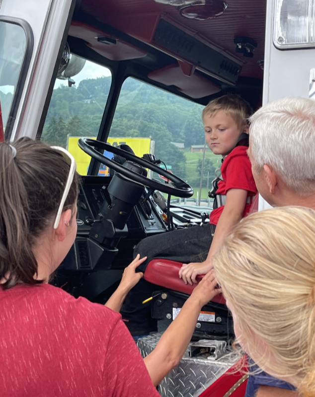 Camp Caring students exploring a fire truck with community helpers in Garrett County, Maryland